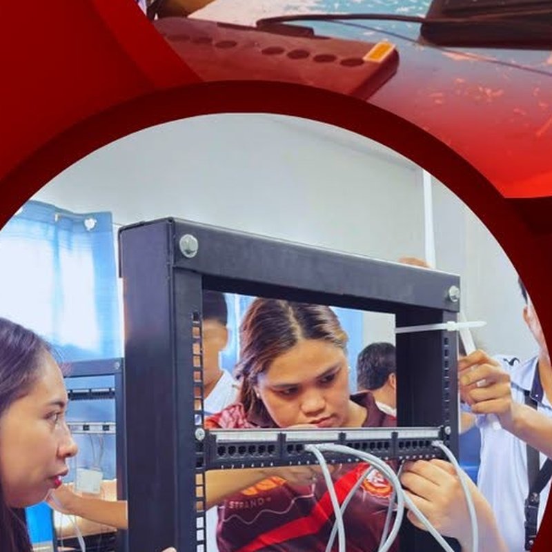 Students installing network equipment on a server rack